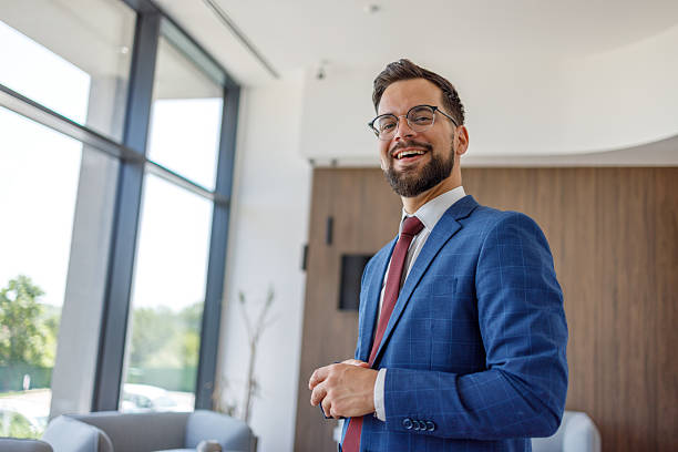 istock Young businessman smiling in modern office building lobby 2227915727
