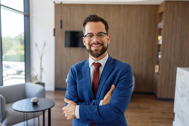 istock Smiling businessman with folded arms in modern office 2227915849