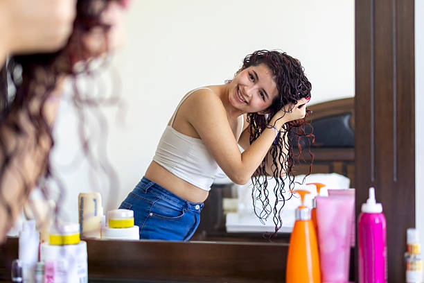 istock Young woman doing her curls 2227923358