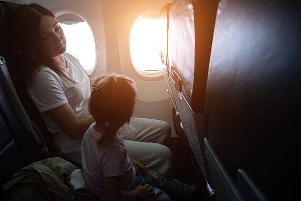 istock Mother and daughter sleeping and playing during flight 2227924261
