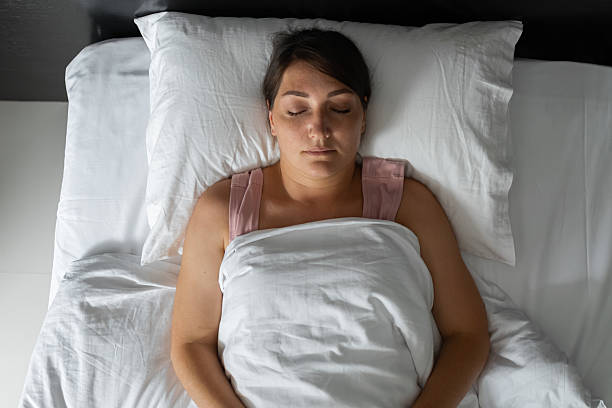 istock Serene woman sleeping peacefully in comfortable bed, enjoying deep sleep 2227924372
