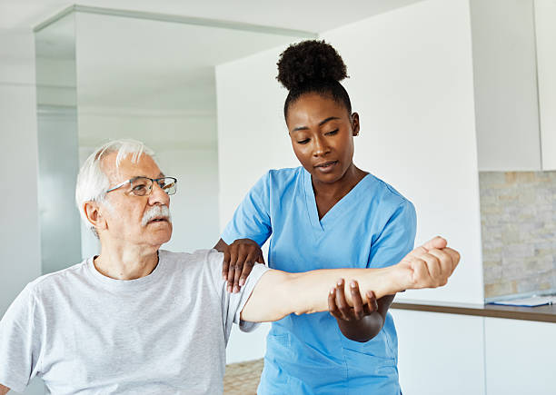 istock senior care exercise physical therapy exercising help assistence retirement home physiotherapy physiotherapist fitness gym strech clinic therapist elderly woman band stretching man 2227929414