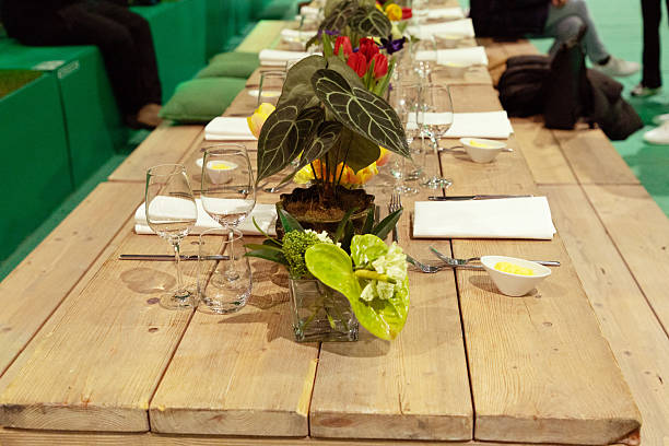Beautifully set dining table featuring fresh flowers, glassware, and napkins, creating an inviting atmosphere for gatherings.