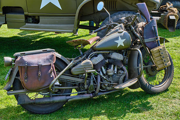 Italy, August 24 -- Veterans of the Italian Bersaglieri military corps aboard the original motorcycles of the Second World War (1939/1945), during a military parade. Characterized by the famous plumed helmet and for always marching at a fast pace, the Bersaglieri are one of the oldest military corps of the Italian army, founded in 1836 by General Alessandro La Marmora. Image in high quality format.