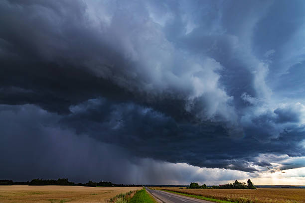 istock WEATHER Dramatic black rain clouds over fields and country road 2227932343