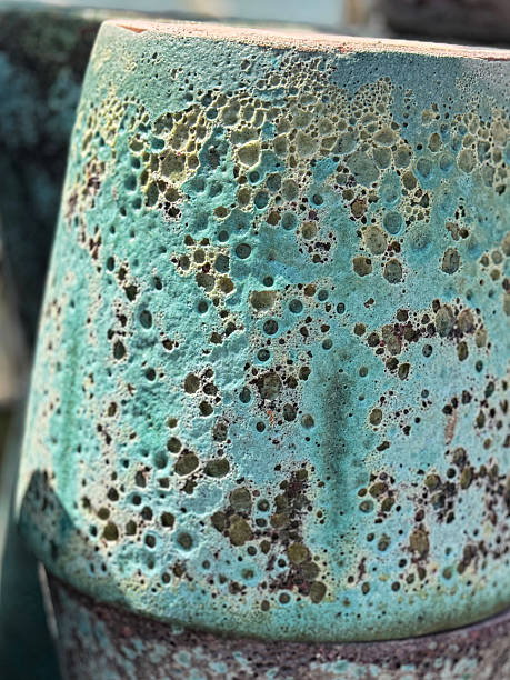 Stock photo shows a rustic planter garden pot in stunning turquoise stoneware, showcasing a beautifully textured reactive glaze finish. This stylish container is ideal for gardening, perfect for holding vibrant flowers, herbs, or decorative plants, adding charm to patios, balconies, and outdoor spaces