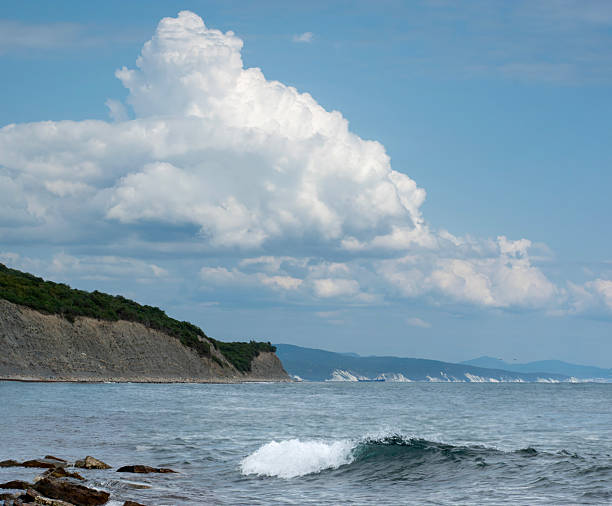 a sea landscape and a blue sky with clouds