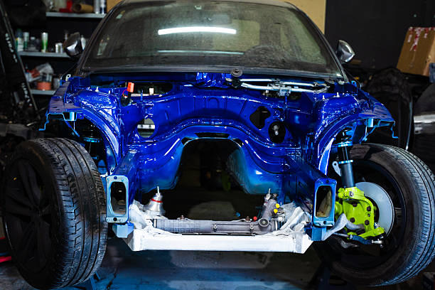 istock Drift Car Chassis Build - Custom Painted and Stripped Drift Project in Progress. Project drift car in a raw phase shows off upgraded suspension, massive tires, and clean detailing work. 2227939498