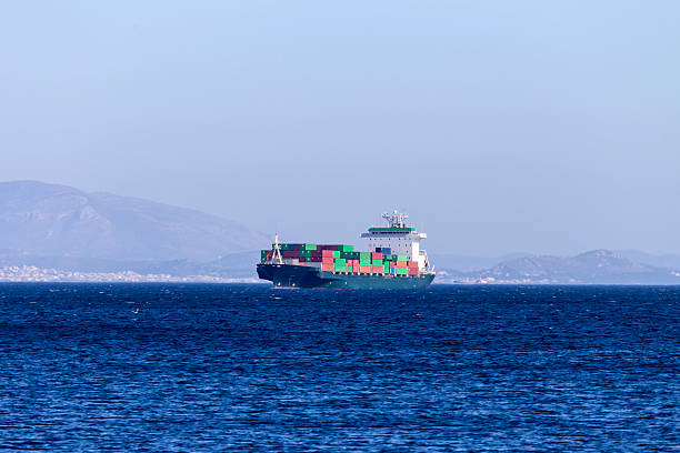 The large, cargo ship sail on the open sea on a sunny, spring day (Greece).