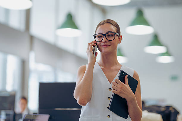 istock A skilled Professional Woman in Office Attire is actively using her Smartphone to communicate 2227946202