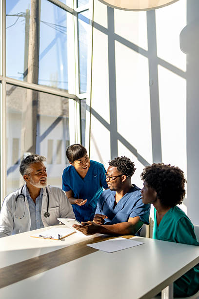 Diverse Medical Team Collaborating in Sunlit Office Setting