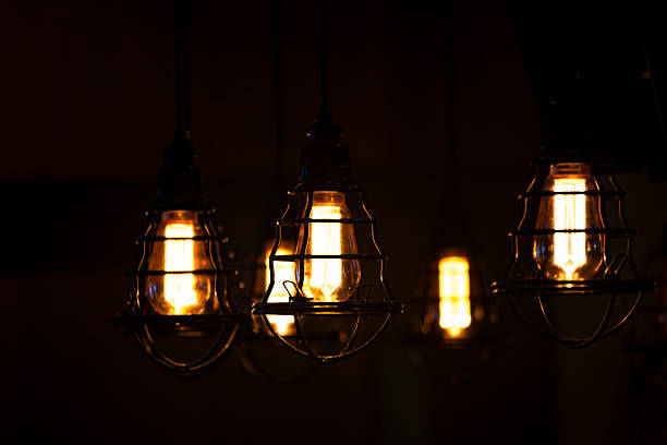 istock Vintage Ambiance: Warmly Glowing Old-fashioned Filament Light Bulbs 2227949014
