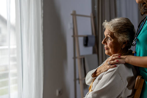 istock Caring Nurse Comforting an Elderly Woman in a Home Setting 2227949395