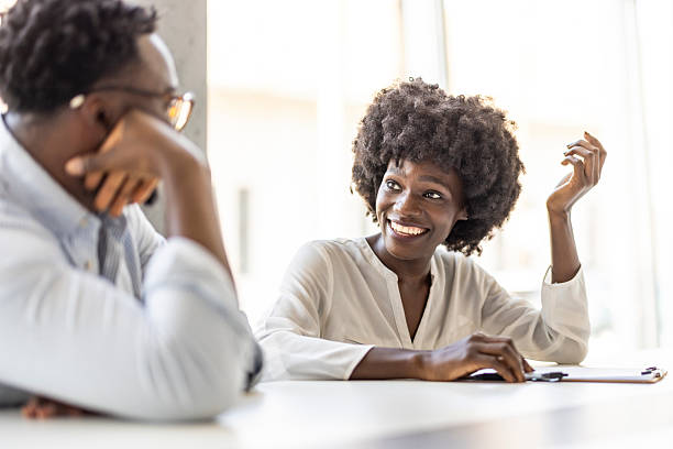 istock Friendly Business Conversation Between Colleagues in Bright Office Setting 2227949412