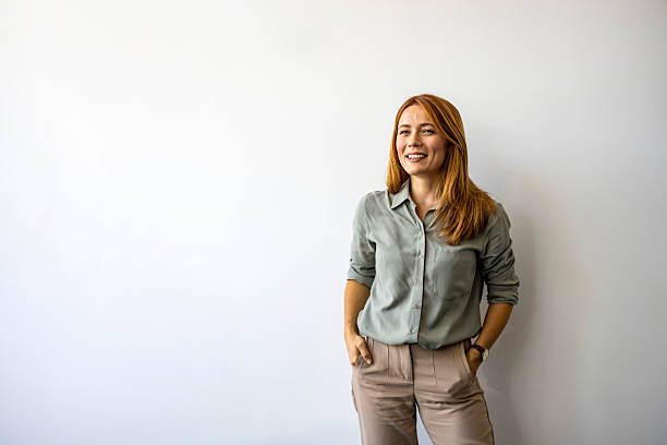 istock Confident Woman Smiling Against Minimalist White Background 2227949429