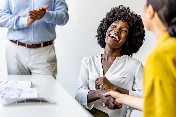 istock Joyful Business Meeting With Handshake and Applause in Office Setting 2227949459