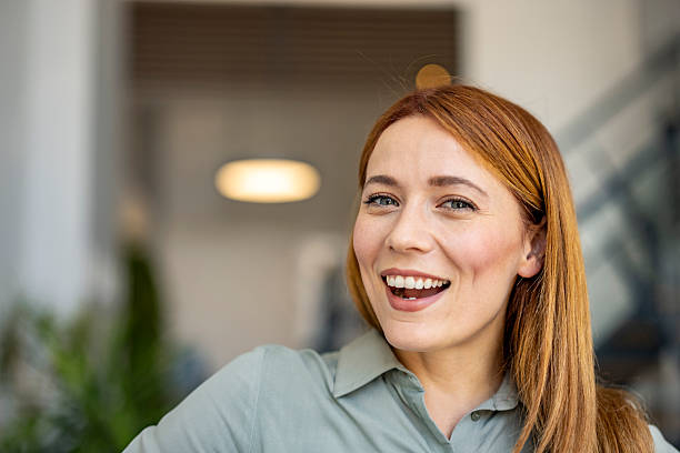 istock Joyful Woman Smiling Brightly in Modern Office Setting 2227949467