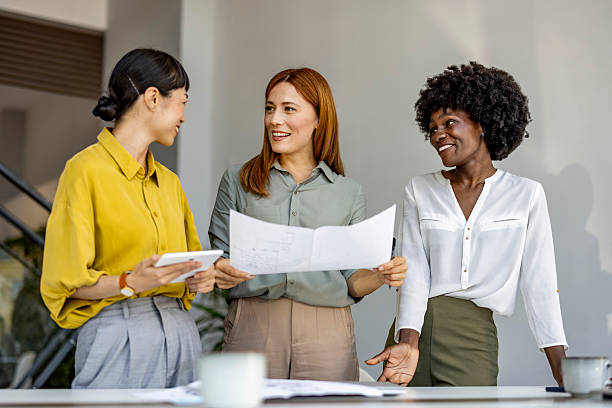 istock Happy Businesswomen Collaborating on Project in Modern Office 2227949522