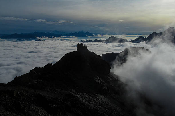 Alps mountains snow ridges view of Monte Rosa massive. Lyskamm, Pollux and Castor summits above the clouds stunning landscape mountains view. Alps high attitude extreme terrain climbing and glacier
