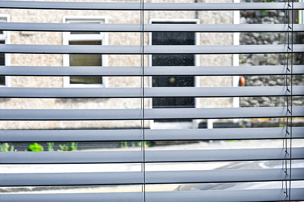 Captivating Light Filtering Through Window Blinds in an Urban Setting Creates a Unique Ambiance