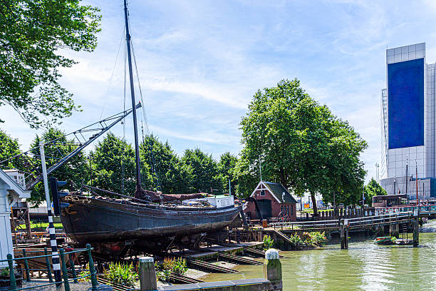 istock Historic Boat Resting on Land in Rotterdam Shipyard Surrounded by Trees. 2227959524