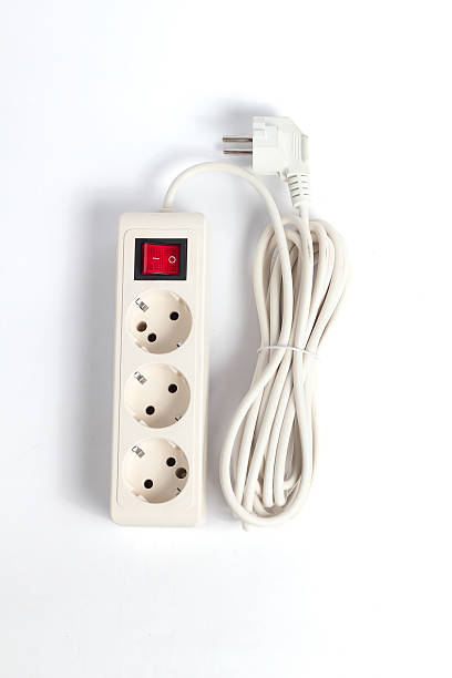 istock white extension cord featuring a power strip with three outlets and a red switch, set against a neutral white background. 2227961188