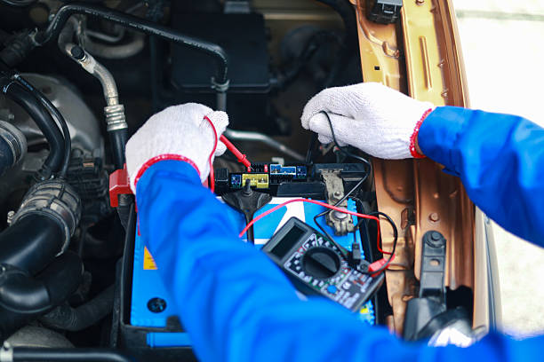 istock Auto mechanics check car engines with digital multimeters, test batteries and fuse boxes, and inspect electrical systems. Car service and maintenance. 2227966769
