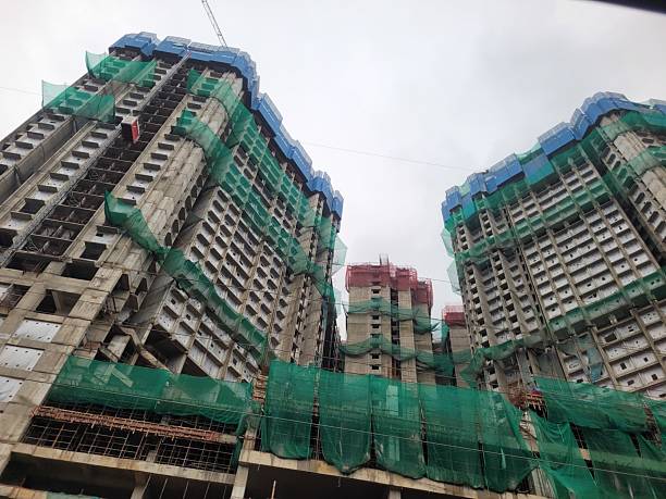 istock Building under construction with scaffolding and green safety net 2227969241