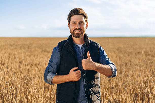 istock Happy farmer gesturing thumbs up in wheat field 2227972305