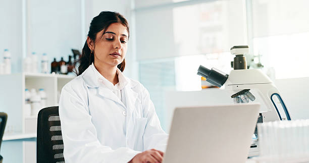 istock Laptop, scientist and woman in laboratory for research, forensic analysis and DNA test. Computer, science and serious medical worker typing email for investigation, chemistry and toxicology report 2227972435