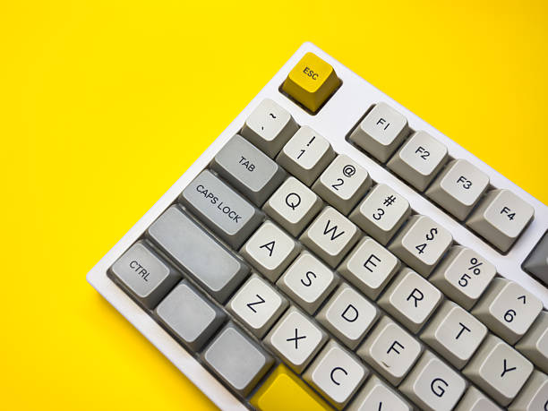 istock White mechanical keyboard with bright Esc key on bright yellow background, minimalism, keyboard buttons. A keyboard with a yellow key on the bottom left 2227972932