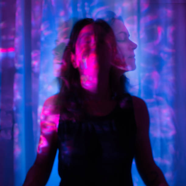 Creative conceptual portrait of a woman featuring a double exposure effect to represent the digital twin idea. The neon-lit environment and artistic lighting evoke themes of data, identity, and modern technology.