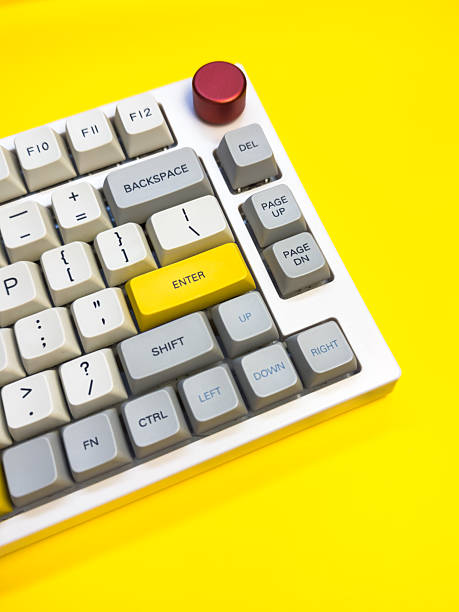 istock White mechanical keyboard with bright Enter key on bright yellow background, minimalism, keyboard buttons. A keyboard with a yellow key on the bottom left 2227972987