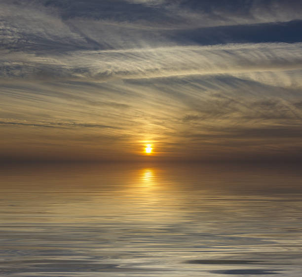istock Sun reflection at sunset sunrise over the water 2227975069