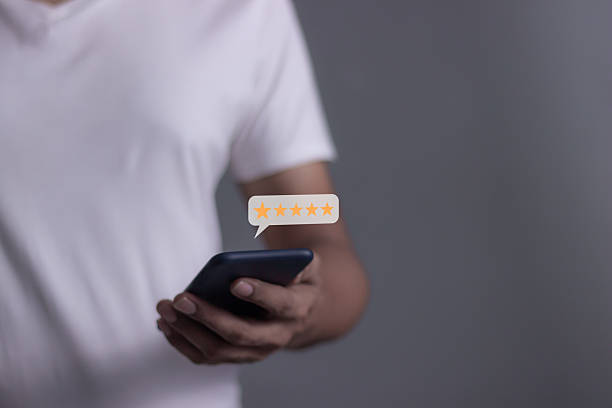 istock Review Customer, Young Man hand using smartphone mobile with five star to review and give 5 stars with very good results in service, Good review 5 star rating choice feedback 2227975100