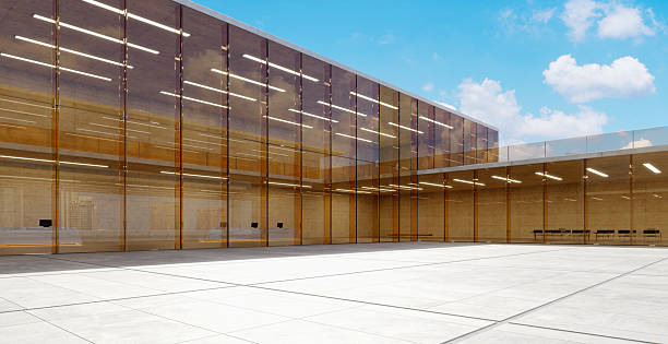 istock 3d rendering modern glass and concrete building reflecting blue sky and clouds 2227975955