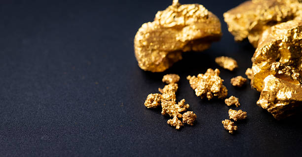 istock Small gold nuggets on black background 2227981809