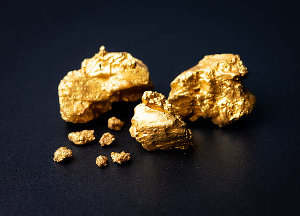 istock Small gold nuggets on black background 2227981825