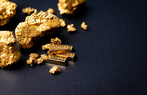 istock Gold block and nuggets on black background 2227981830