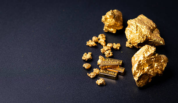 istock Gold block and nuggets on black background 2227981845