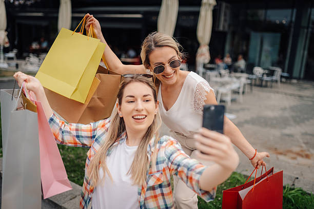 istock Two happy women taking selfie after shopping spree 2227982013