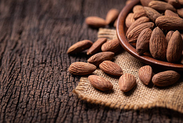 Bowl of almonds on a wooden surface