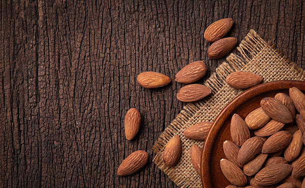 Bowl of almonds on a wooden surface