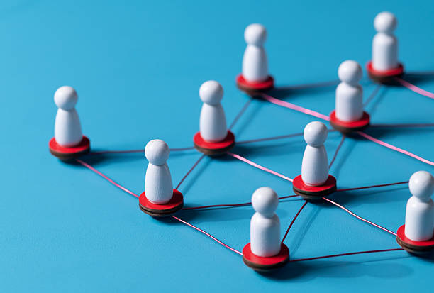 istock Wooden human figures connected by glowing thread  HR network and team connectivity on blue Background 2227982182