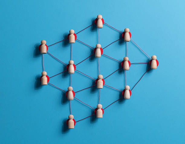 istock Wooden human figures connected by glowing thread  HR network and team connectivity on blue Background 2227982195