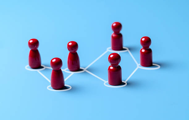 istock Wooden human figures connected by glowing thread  HR network and team connectivity on blue Background 2227982268