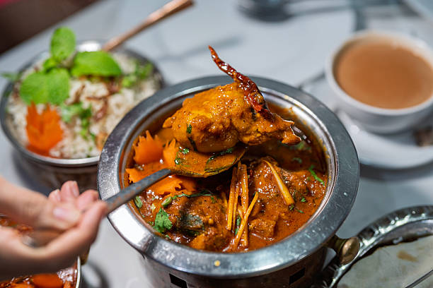 istock Serving Indian Curry Chicken from a Copper Pot 2227982343