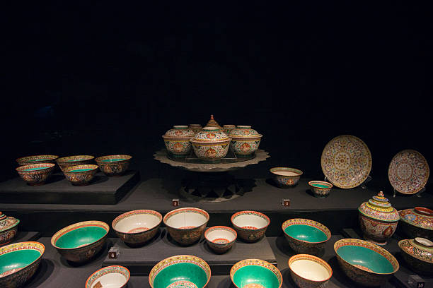 Antique container, bowl, plate, antique Asian object on black background.