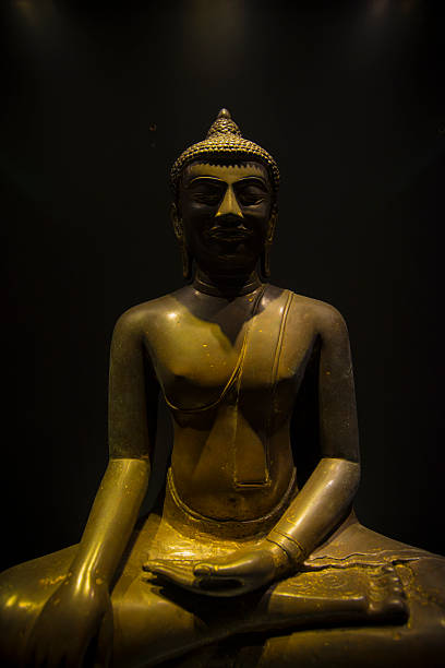 golden Avalokiteshvara Buddha statue with multiple arms and ornaments. Avalokiteshvara is the Bodhisattva of Mahayana Buddhism, the buddha of compassion, an emanation of Buddha Amitabha, embodies the ideal of universal compassion. frontally