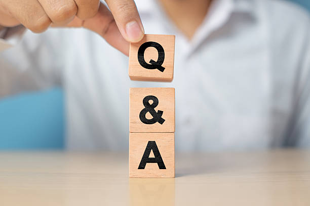 istock Q and A alphabet on wooden cube in hand hold with background. Question and answer meaning 2227983405